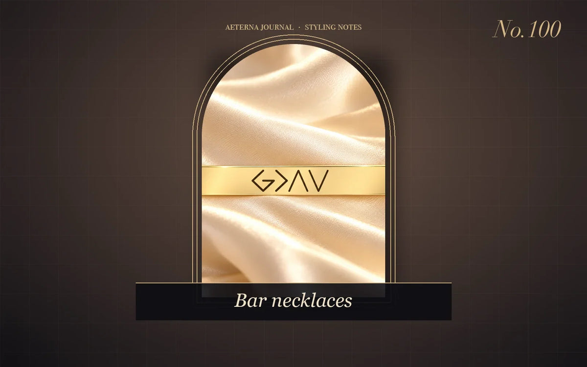Gold-tone horizontal bar necklace with an engraved symbol phrase