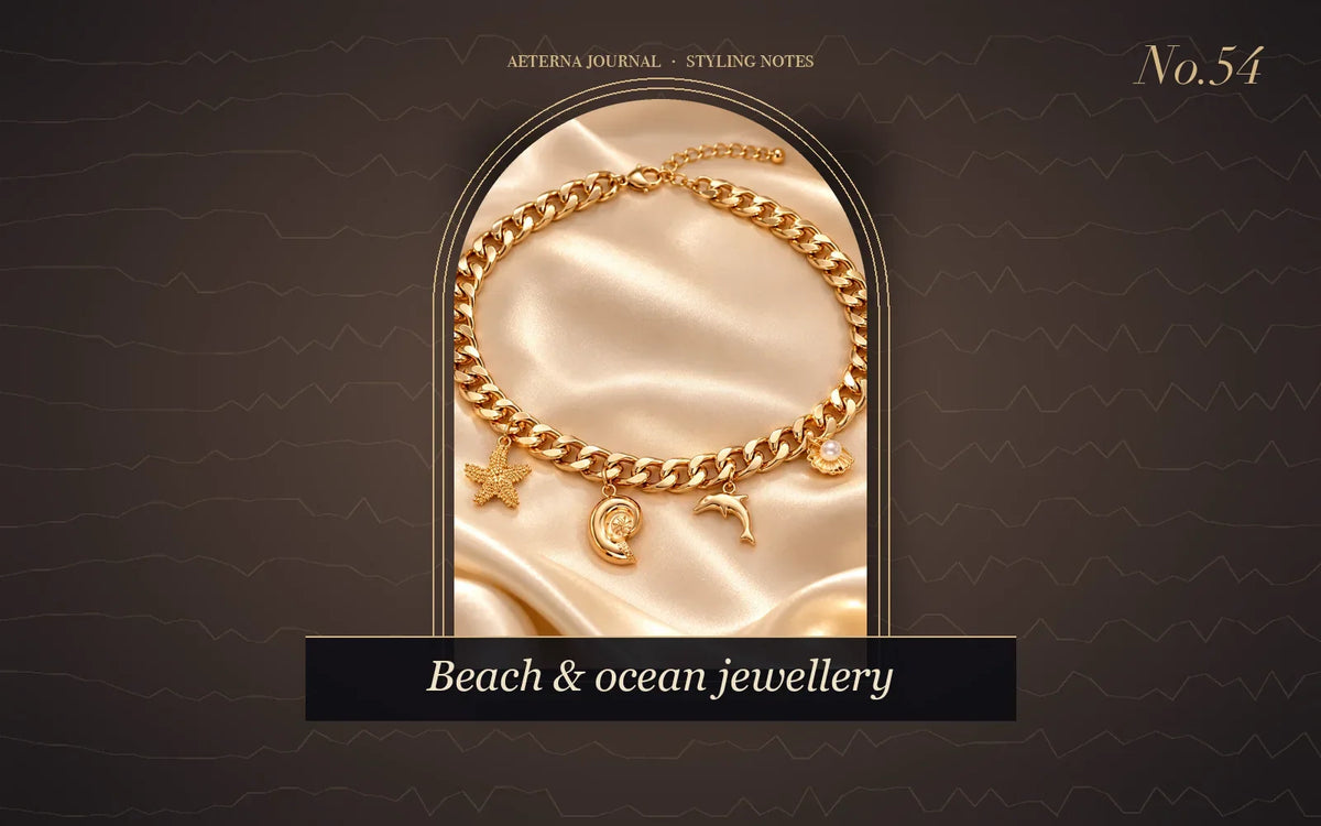Gold-tone chain bracelet with starfish, moon and dolphin charms