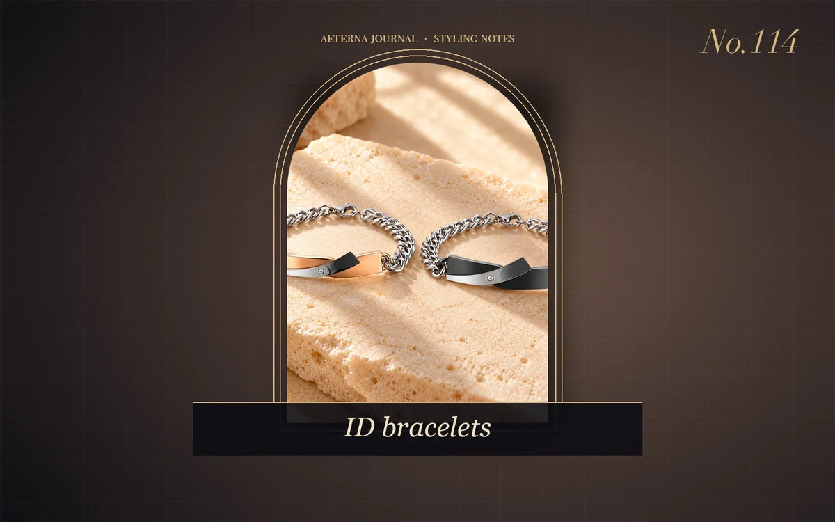 Two steel chain bracelets with black and silver curved ID plates