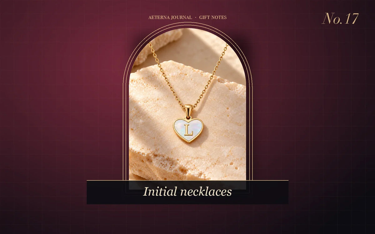 Heart-shaped white shell pendant with an initial letter on a fine chain