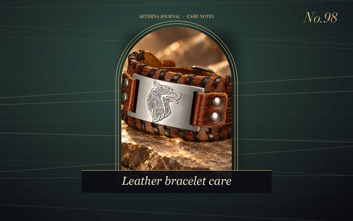 Brown leather cuff with an engraved wolf-head metal plate