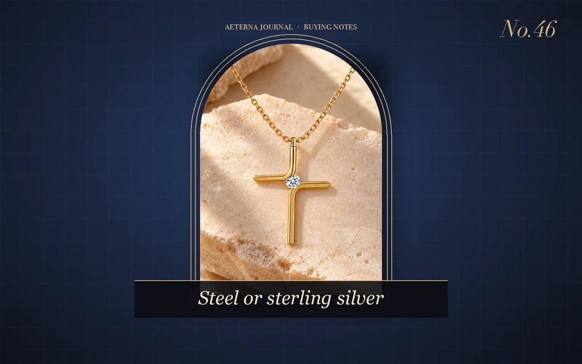 Gold-tone stainless steel cross pendant with a small stone