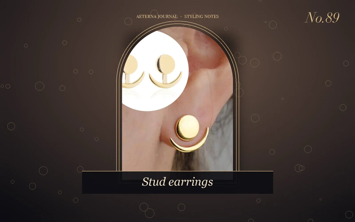 Gold-tone disc and crescent ear jacket stud earrings worn on the lobe