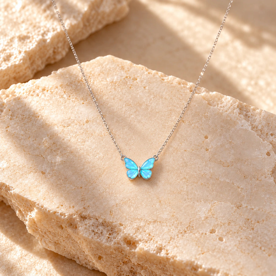 Generated concept artwork for Blue Luminous Butterfly Glow Dark Necklace; illustrative only, not an exact product photograph